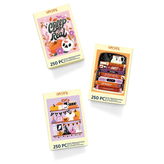 The WerkShoppe Creep It Real | 250 Piece Jigsaw Puzzle Set includes three festive Halloween puzzles, each presented in a yellow box with seasonal designs featuring pumpkins, books, and autumn decorations on a white background—an ideal fall gift for puzzle enthusiasts.