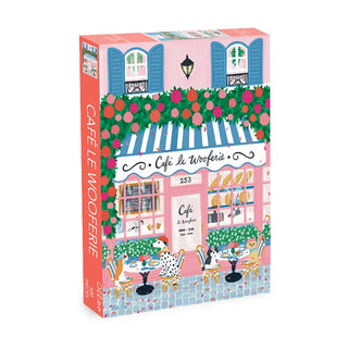 Experience the charm of Paris with Olleo Puzzles’ Café Le Wooferie | 500 Piece Jigsaw Puzzle, featuring a vibrant café scene with blue shutters, flowers, and two dogs at outdoor tables.