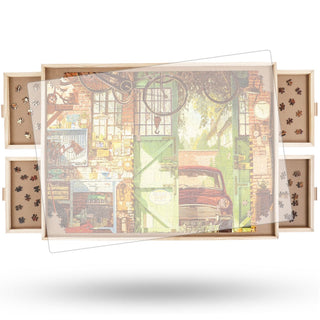 The ALL4JIG Portable Wooden Jigsaw Puzzle Table features sliding side drawers and holds a partially completed 500-piece puzzle with a vintage car and bicycles garage scene.