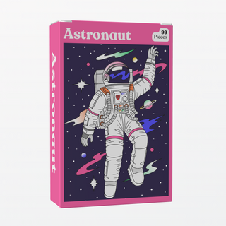 The Astronaut | 99 Piece Jigsaw Puzzle by Puzzledly features a space-themed design with an astronaut among planets and stars. This compact, pocket-sized mini puzzle offers portable fun with 99 ribbon-cut pieces.