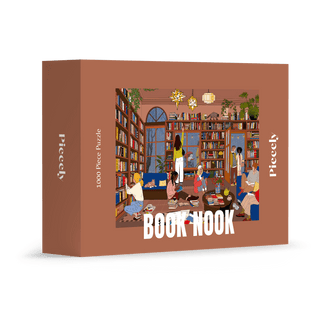 The Piecely Book Nook | 1,000 Piece Jigsaw Puzzle features a cozy library scene with people reading, comes in plastic-free packaging, and has a luxurious soft-touch finish.