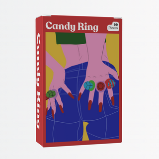 A red box labeled "Candy Ring | 99 Piece Jigsaw Puzzle" by Puzzledly features an illustration of hands with candy rings over denim-clad hips—ideal as mini decor or for storing your pocket-sized puzzle.