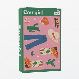 Puzzledly’s Cowgirl | 99 Piece Jigsaw Puzzle features a hat, boots, jeans, cacti, a horseshoe, and a bandana on pink—perfect for on-the-go fun.
