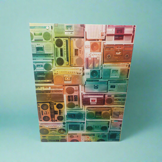 Da Boom by Unified Pieces is a 1,000-piece jigsaw puzzle featuring a vibrant pattern of vintage boomboxes on light blue—ideal for hip hop fans and puzzle lovers alike.