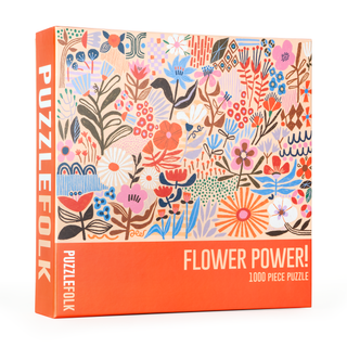 The Puzzlefolk Flower Power | 1,000 Piece Jigsaw Puzzle features a vibrant floral illustration with colorful blooms on the front of the box.