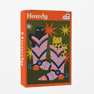 The Howdy | 99 Piece Jigsaw Puzzle by Puzzledly features two cats in vibrant cowboy boots, includes 99 ribbon-cut pieces, and is pocket-sized for on-the-go fun.