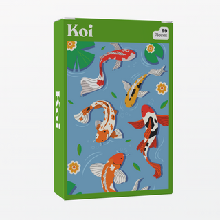 A green box labeled "Koi | 99 Piece Jigsaw Puzzle" by Puzzledly contains a mini puzzle showing illustrated koi fish swimming with lily pads and flowers on a blue background.