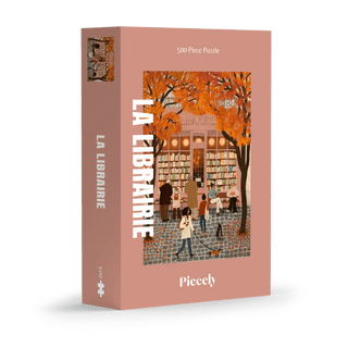 The Piecely La Librairie | 500 Piece Jigsaw Puzzle showcases an autumn bookstore scene with people and falling leaves, and comes in plastic-free packaging.