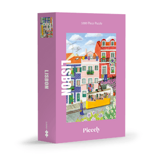 Piecely’s Lisbon | 1,000 Piece Jigsaw Puzzle features Lisbon’s colorful buildings and yellow tram, with a pink border, premium soft-touch finish, and plastic-free packaging for an eco-friendly touch. Brand name appears at the bottom.