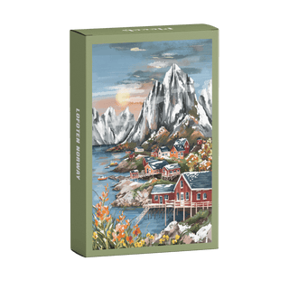 The Piecely Lofoten Norway 99 Piece Jigsaw Puzzle comes in plastic-free packaging and features red houses by the water, snow-capped mountains, and flowers, beautifully illustrated in a scenic view.