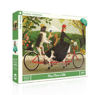 Miss Moon's Bike by New York Puzzle Company is a 1,000-piece jigsaw puzzle featuring a whimsical scene of a woman riding a tandem bicycle with several dogs, set against a lush, leafy background.
