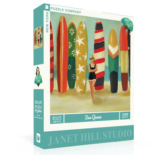 The Sea Queen | 500 Piece Jigsaw Puzzle by New York Puzzle Company features a whimsical beach scene with a woman in a swimsuit and colorful surfboards, capturing relaxed seaside charm.