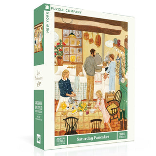 The New York Puzzle Company’s “Saturday Pancakes” is a 300 piece jigsaw puzzle featuring original art of a family making pancakes in a cozy kitchen, proudly made in the USA.