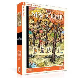 The Leaf Peepers | 1,000 Piece Jigsaw Puzzle by New York Puzzle Company features Ricardo Liniers' autumn forest cover with whimsical anthropomorphic leaves and trees.