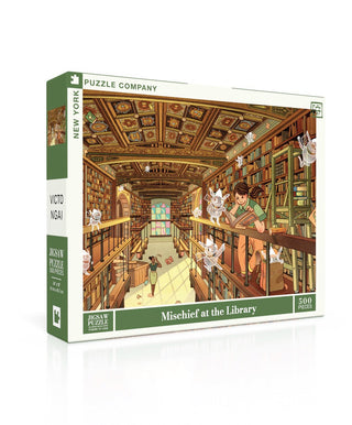 The Mischief at the Library | 500 Piece Jigsaw Puzzle by New York Puzzle Company depicts a fantasy library scene filled with flying books and playful mythical creatures.