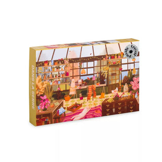 The Trevell Dans La Serre 1,000 Piece Jigsaw Puzzle features a vibrant greenhouse scene with plants, flowers, and gardening tools—perfect for hours of engaging fun for all ages.