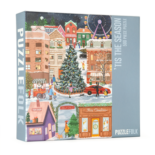 Puzzlefolk’s "Tis the Season" 500 piece jigsaw puzzle features a festive town square with a Christmas tree and holiday lights—perfect for cozy winter nights.