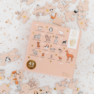The Bow Wow "Breeds" 42 Piece Jigsaw Puzzle by Jollity & Co. features illustrated dog breeds, making it a fun and thoughtful gift for any dog lover or puzzle fan.