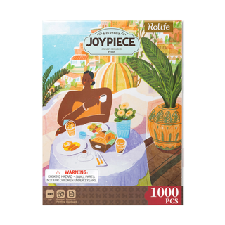 The Amalfi Holiday 1,000 piece jigsaw puzzle by Robotime features an illustrated woman at a breakfast table with plants and a city view—ideal for adult puzzle enthusiasts.
