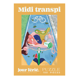 The Midi Transpi | 100 Piece Jigsaw Puzzle by Jour Férié features a bike lane scene with a basket holding gym clothes, water bottle, snack, and keys. This ribbon cut puzzle is proudly made in France.