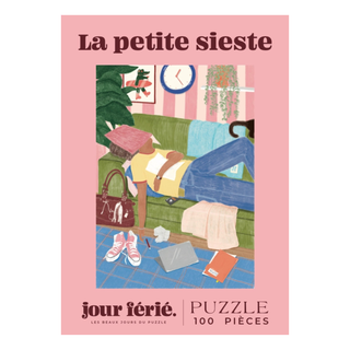 Illustration of a person napping on a couch amid scattered items, with "La Petite Sieste" and "100 Piece Jigsaw Puzzle" by Jour Férié on the border; features ribbon cut pieces and is made in France.