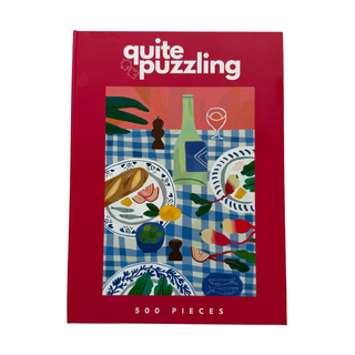 The Quite Puzzling "Radish in the Joy" 500-piece jigsaw puzzle comes in a book-style box with a red border, showing an illustrated dining table scene—an ideal coffee table puzzle.