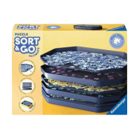 A box of Ravensburger Sort & Go Ultimate, with a puzzle sorting system featuring stacked black trays filled with jigsaw pieces, displayed on the front of its bright yellow packaging.