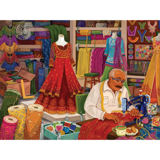 Step inside The Tailor’s Shop with this charming 500 Piece Jigsaw Puzzle by Laila Luxury Puzzles. Featuring a tailor sewing a red dress with gold details amid a vibrant fabric shop filled with colorful textiles, dresses, and sewing supplies, this puzzle beautifully captures the artistry of traditional craftsmanship. Ideal for enthusiasts, The Tailor’s Shop comes in a decorative magnetic box for convenient storage and stylish display.