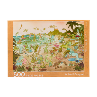 A cartoon illustration on the Dinosaur Beach | 500 Piece Jigsaw Puzzle showing numerous dinosaurs enjoying a beach day, including swimming, surfing, and playing in the sand.