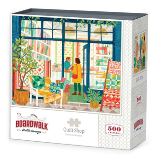 The Quilt Shop | 500 Piece Jigsaw Puzzle by Boardwalk Puzzle Company features a charming illustrated quilt shop scene with two people conversing inside, vibrant quilts on display, and colorful décor. Made from premium blue board, it offers a satisfying puzzling experience.