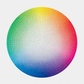 The Play Group’s 1000 Colours Wheel is a completed 1,000 piece jigsaw puzzle showing a smooth color gradient spectrum—green to yellow, orange, red, pink, purple, and blue—like an artist’s color wheel.