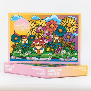 Discover Small World, a 500-piece jigsaw puzzle by Sunshine Puzzles. This recycled puzzle features a vibrant cartoon garden scene with oversized flowers, mushrooms, tiny houses, and a bee under a bright blue sky. The matte surface reduces glare for a more enjoyable assembling experience, with the Sunshine Puzzles logo displayed on the box.