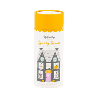 A cylindrical container with a yellow lid labeled "Spooky House | 300 Piece Jigsaw Puzzle" by My Mind's Eye, featuring a haunted house illustration with cats and pumpkins in the windows.