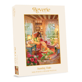 Sunday Rain 500 Piece Jigsaw Puzzle by Reverie Puzzles featuring Maxine Vee artwork of a woman knitting in an armchair with two small green pet dragons in a rainy room.