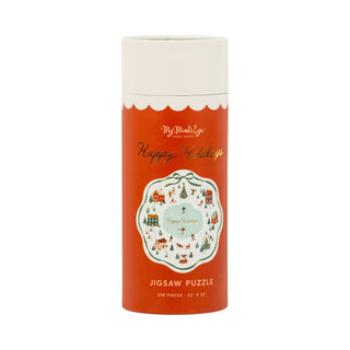 A cylindrical box labeled Happy Holidays by My Mind’s Eye contains a 298-piece chipboard jigsaw puzzle featuring a charming winter village illustration on the front.