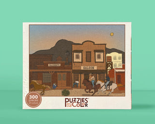 Legends of Cowtown 300 Piece Jigsaw Puzzle box featuring an illustration of a Western town with Black cowboys, a blacksmith shop, a saloon, and people on horseback.