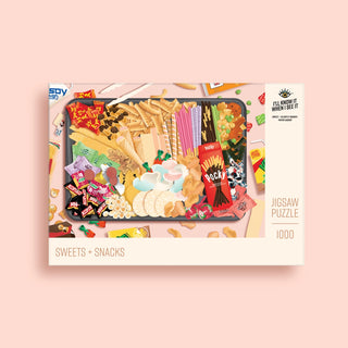 The Sweets + Snacks | 1,000 Piece Jigsaw Puzzle by I’ll Know It When I See It features Asian treats on a tray and the “Sweets + Snacks” label, made from recycled materials for eco-friendly fun.