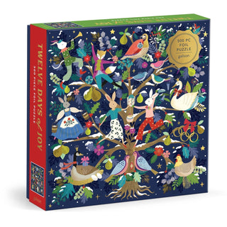 The 12 Days of Joy | 500 Piece Jigsaw Puzzle by Galison features illustrated animals and festive items arranged in a decorated tree, celebrating the classic “Twelve Days of Christmas” song. Shimmering foil accents and whimsical details capture the holiday spirit, making this charming puzzle the perfect seasonal activity for fans of the 12 Days of Christmas theme.
