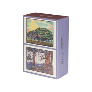 A purple box labeled “William S. Rice | 120 Piece Double-Sided Jigsaw Puzzle Set” by Pomegranate features two illustrated landscape scenes on the front, each depicting trees and nature in distinct artistic styles inspired by William S. Rice’s block prints and the Arts and Crafts movement.