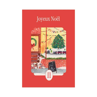 The la pauz Joyeux Noël | 99 Piece Jigsaw Puzzle features a festive holiday scene with a Christmas tree, train set, dog by the window, and Chocolat Chaud chalkboard—a charming and merry mini puzzle perfect for the season.