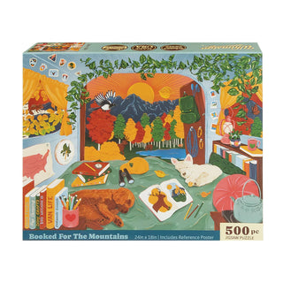 Whimsigo’s “Booked For the Mountains | 500 Piece Jigsaw Puzzle” comes in a box featuring an illustrated cozy room with pets and mountain scenery visible through the window, and is proudly made in the USA.