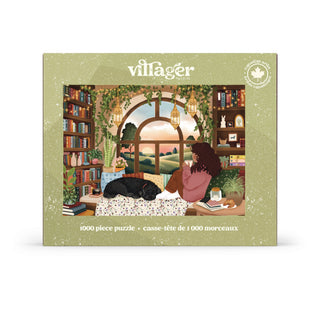 The Book Nook | 1,000 Piece Jigsaw Puzzle by Villager Puzzles features Tara Younggren’s heartwarming illustration of a woman and her black dog unwinding by a window with a beautiful view, surrounded by books and lush plants—an ideal book lover puzzle for relaxing afternoons.