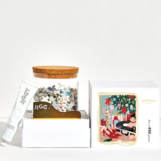 The Kitty Christmas 450-piece jigsaw puzzle by Jiggy Puzzles features Ana Hard’s festive cat artwork and comes in a glass jar with puzzle glue and a wooden tool—perfect for celebrating girl power.