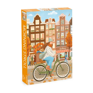 Morning Stroll | 500 Piece Jigsaw Puzzle by Olleo Puzzles features a woman cycling with her dog among autumn leaves and vibrant buildings—ideal for those who enjoy Amsterdam or Dutch city scenes.