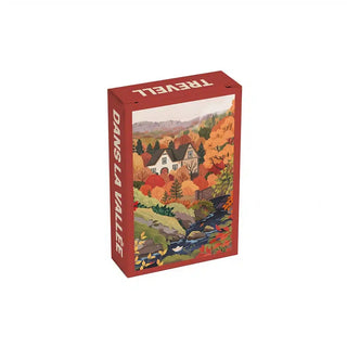 Rectangular Dans La Vallée | 99 Piece Jigsaw Puzzle box featuring an illustration of a cottage nestled in a vibrant autumnal forest with a stream in the foreground.