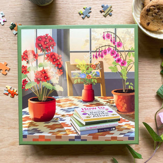 Introducing "Blossom," a 500 piece jigsaw puzzle by ViSSEVASSE. This delightful puzzle showcases an illustration of potted plants and flowers arranged on a table, with the book "How to Keep Plants Alive," alongside cookies and scattered puzzle pieces. Crafted from FSC-certified materials, it's perfect for eco-friendly puzzling.