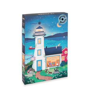 Experience mindful puzzling with the Trevell Le Phare | 500 Piece Jigsaw Puzzle, featuring an enchanting illustration of a seaside lighthouse, a quaint shop labeled "Le Phare," a playful dog, and a night sky adorned with a crescent moon and stars. Crafted from eco-friendly materials, this charming puzzle offers hours of relaxing fun.