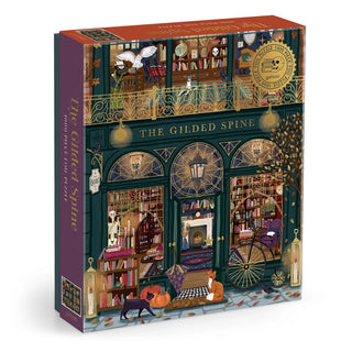 Discover “The Gilded Spine” 1,000 Piece Jigsaw Puzzle by Galison—a gothic bookstore scene adorned with an illustrated storefront, books, pumpkins, cats, and autumn leaves. The sign reads “The Gilded Spine,” making it the perfect cozy challenge for the spooky season.