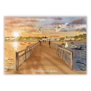 Enjoy a sunset stroll in Andernos-les-Bains with Aparté's "Andernos Les Bains | 1,000 Piece Jigsaw Puzzle," featuring a boardwalk over water, people, seagulls, and boats—all beautifully illustrated by Charlotte Smith.
