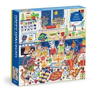 The Happy Hanukcats 500 Piece Jigsaw Puzzle by Galison features illustrated cats celebrating Hanukkah with festive food and feline decorations in a colorful kitchen.